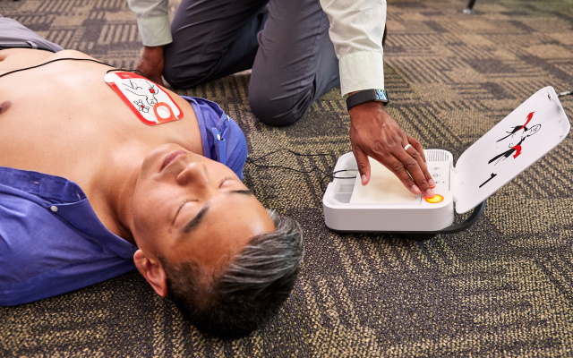 LIFEPAK CR2 In Use Man w Pads Woman Pushes Shock 2