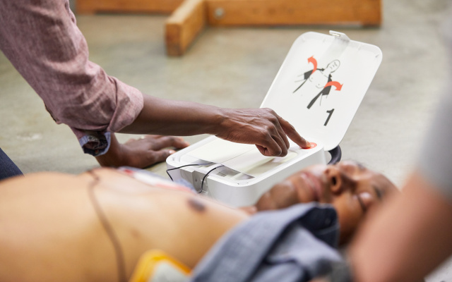 LIFEPAK CR2 In Use Man w Pads Woman Pushes Shock