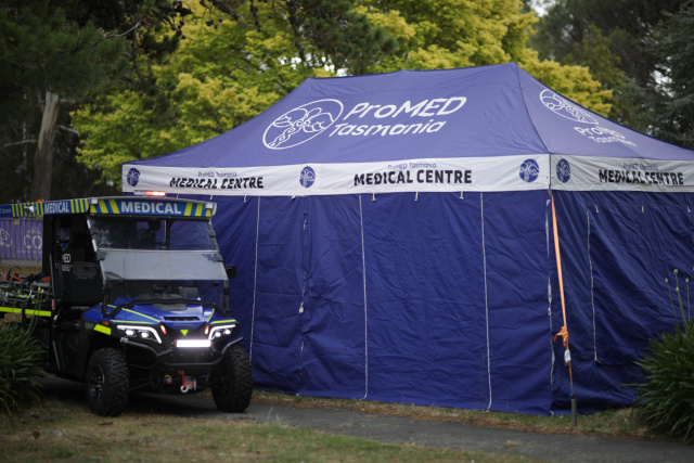 ProMED patient transport buggy beside a branded medical centre marquee